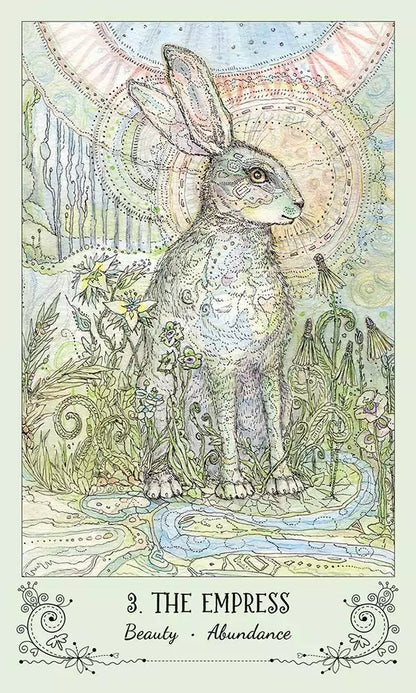 Spiritsong Tarot card featuring a rabbit adorned with intricate patterns surrounded by a lush flowering landscape.