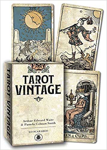 Tarot Vintage deck by Lo Scarabeo showing aged sepia-toned Sun card and other classic RWS cards alongside the box — a 2021 linen-finish antique-style Waite-Smith edition.