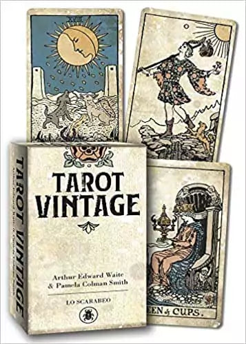 Tarot Vintage deck by Lo Scarabeo showing aged sepia-toned Sun card and other classic RWS cards alongside the box — a 2021 linen-finish antique-style Waite-Smith edition.