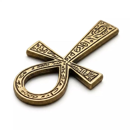 An ornate bronze ankh pendant with intricate designs. The ankh symbolizes life and immortality in ancient Egyptian culture.