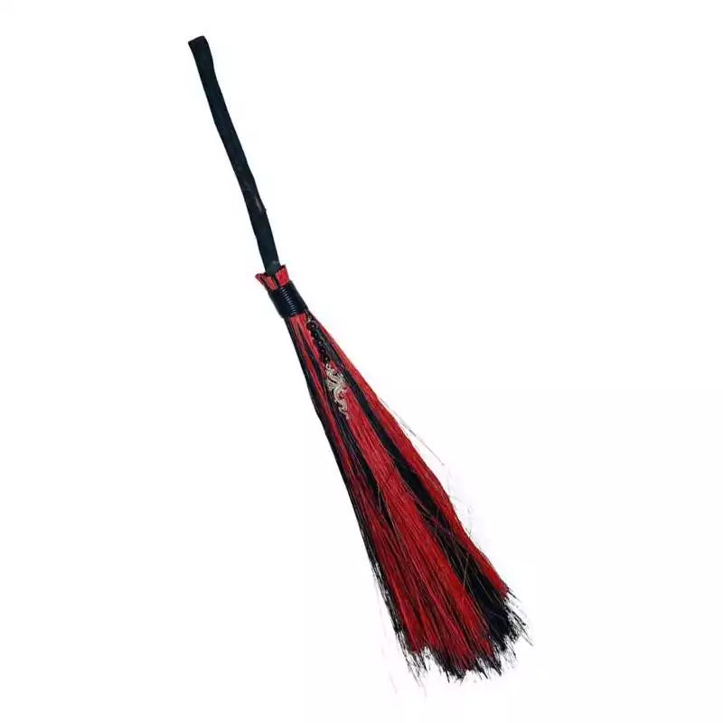 Dragon besom broom with black handle and red and black fibre bristles shown from a different angle — a decorative and functional altar sweeping tool.
