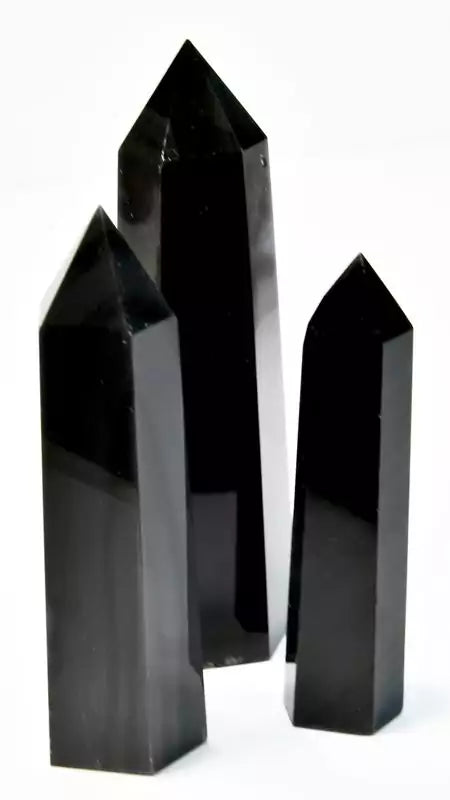 One pound bulk lot of silver sheen black obsidian obelisk towers ranging 3 to 4 inches, showing jet-black volcanic glass with internal silver metallic sheen flash.