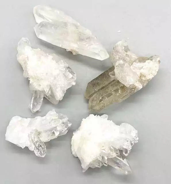 1 lb natural quartz crystal cluster collection showing multi-point clear quartz formations in various sizes for grids and altar work.