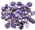 A pile of polished charoite tumbled stones in rich swirling violet and lavender patterns, the rare Siberian crystal, sold in 1 lb bulk lots.