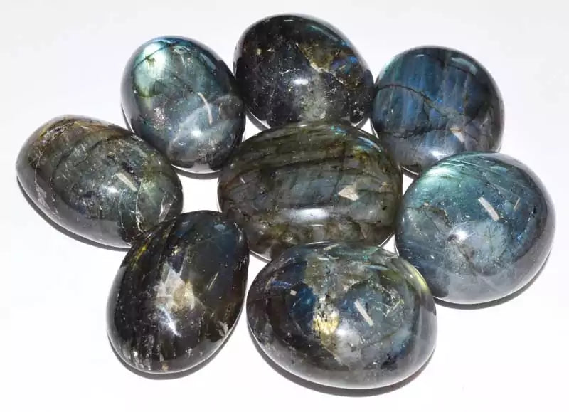 Large 2-inch polished labradorite tumbled stones in pile showing vivid blue and green labradorescence flash, one pound bulk lot