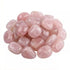 Collection of polished rose quartz tumbled stones in assorted sizes — soft pink heart chakra crystals for bulk crystal grids, altars, and self-care rituals.