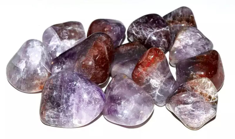 A collection of Super 7 tumbled stones (Melody Stone) showing mixed minerals of amethyst, smoky quartz, and golden rutile inclusions in a 1 lb bulk lot.