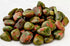 Unakite tumbled stones 1 lb bulk — polished smooth stones in characteristic mottled green and pink pattern for heart and third eye chakra work.