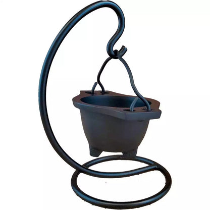 Black cast iron hanging cauldron on a curved iron stand — showing the suspended ritual cauldron in full-height display for altar use.