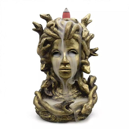 Detailed resin sculpture of Medusa with snakes for hair designed as backflow incense burner with atmospheric smoke cascading