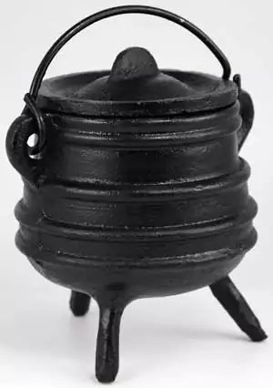 Small classic black ribbed cast iron cauldron with lid and three legs, shown on white background as a traditional altar ritual vessel