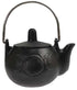 Small black cast iron cauldron with rounded body and handle featuring embossed crescent moon designs, three-legged base shown on white background