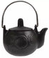Small black cast iron cauldron with rounded body and handle featuring embossed crescent moon designs, three-legged base shown on white background