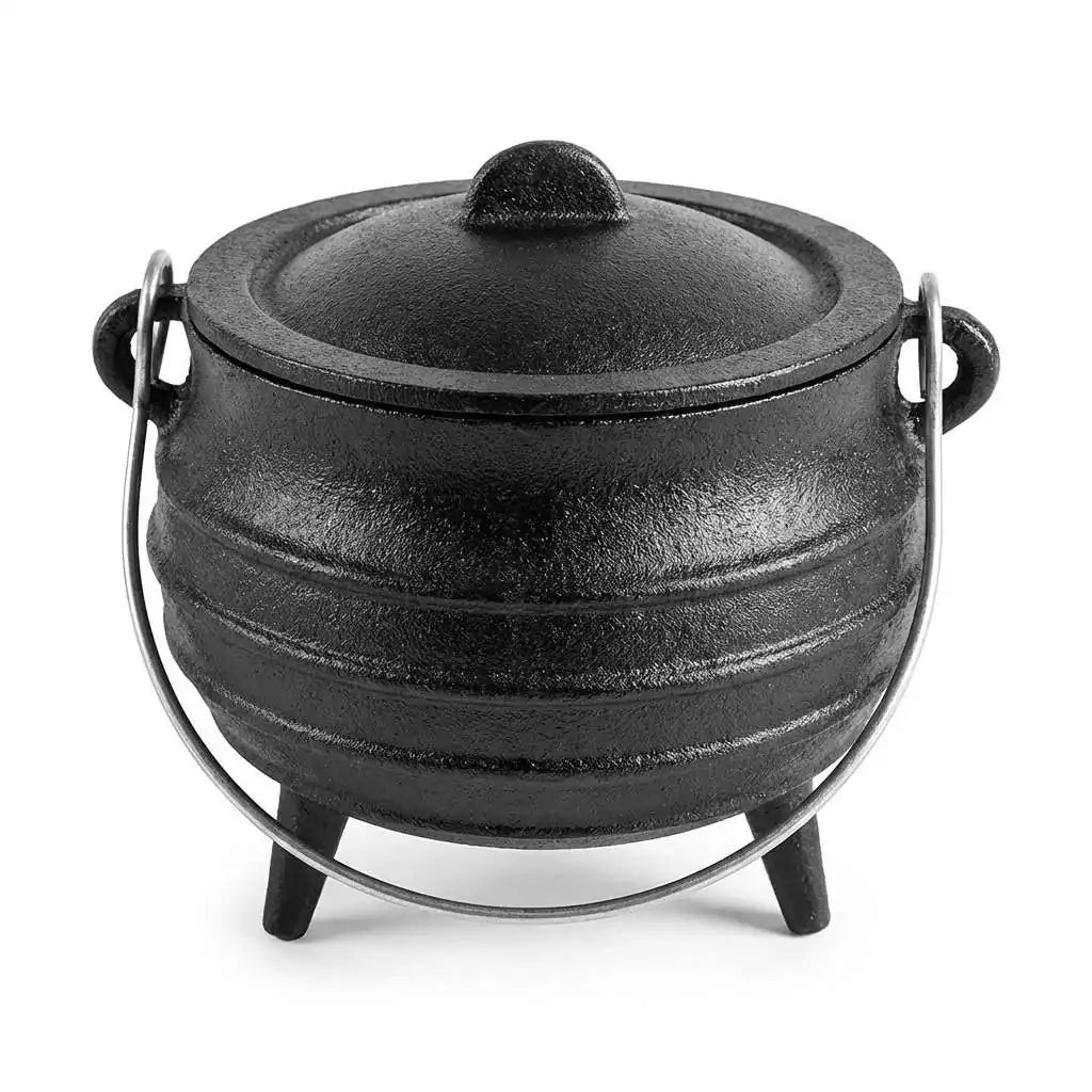 Black 5-inch cast iron cauldron with lid and handle on three legs for burning loose incense smudge herbs charcoal and ritual spell materials on the altar
