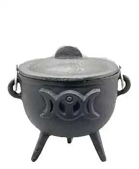 Black cast iron cauldron with a lid, three legs, and Triple Moon decorative symbols embossed on the exterior — Wiccan altar vessel.