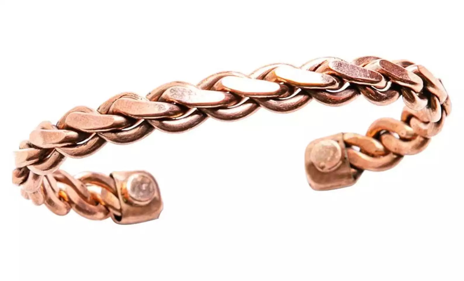 Braided copper open-cuff bracelet showing magnetic ends and rope-twist pattern — traditional healing jewelry close-up.