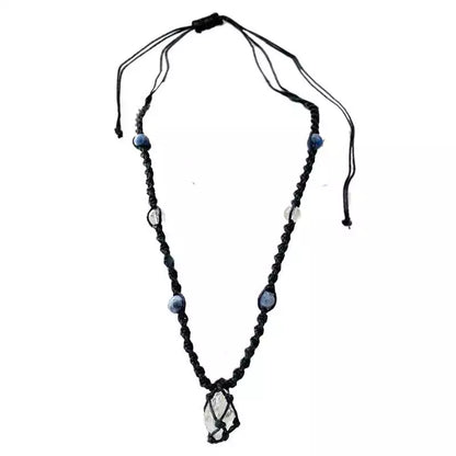 Handmade cord necklace with a central clear and blue sodalite pendant surrounded by beads on a black adjustable cord.