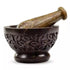 Hand-carved soapstone mortar and pestle set with intricate leaf and vine relief design around the exterior, used for grinding herbs and resins.