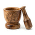 Wooden mortar and pestle with carved pentagram design on the exterior — natural mango wood finish with sturdy round base and tapered pestle.