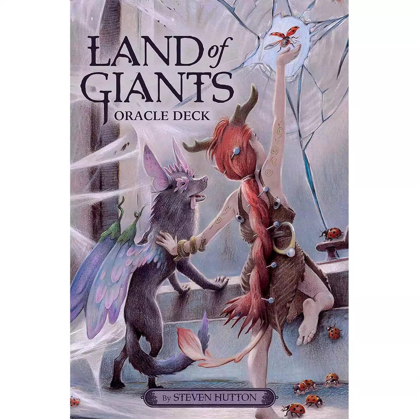 Land of Giants Oracle deck cover showing two small fairy folk, one with wings, in an abandoned manor with spider webs and ladybugs, one reaching toward a butterfly against a cracked window, by Steven Hutton.