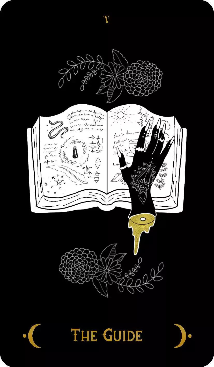 Macabre Tarot The Guide card featuring an open book with mystical symbols and a decorated hand reaching toward it, surrounded by flowers.