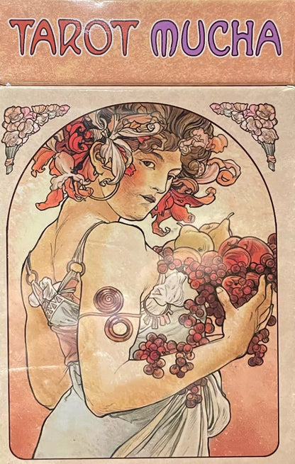 Tarot Mucha Art Nouveau deck cover illustration — woman adorned with flowers and fruit holding grapes, &