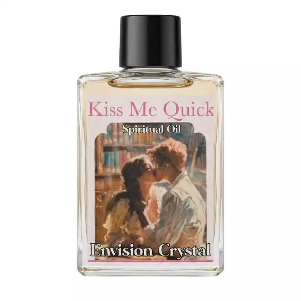 Small 4-dram bottle of Kiss Me Quick ritual oil by Envision Crystal with a romantic couple illustration label, for love-drawing candle and mojo bag anointing.