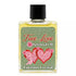 Small bottle of True Love spiritual anointing oil with green label adorned with pink hearts and cherubs and black cap by Envision Crystal for love rituals