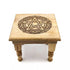 Carved wooden pentagram altar table with intricately cut five-pointed star design and raised leg platform for ritual display