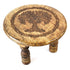 6-inch round wooden altar table with a carved Tree of Life design on the surface and three sturdy wooden legs supporting it.