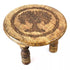 6-inch round wooden altar table with a carved Tree of Life design on the surface and three sturdy wooden legs supporting it.