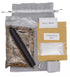 Full Moon Ritual Kit contents displayed — bag of herbs, black candle, cleansing salt packet, and small herb pouch on light gray background for lunar cleansing ritual.