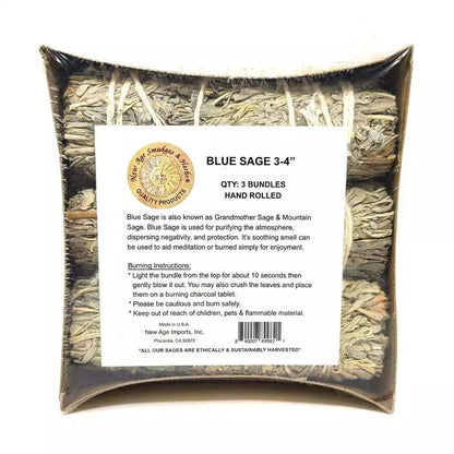 Three bundles of blue sage smudge sticks hand-rolled and packaged in a square container with descriptive label — a 3-pack for regular calming space-clearing practice.
