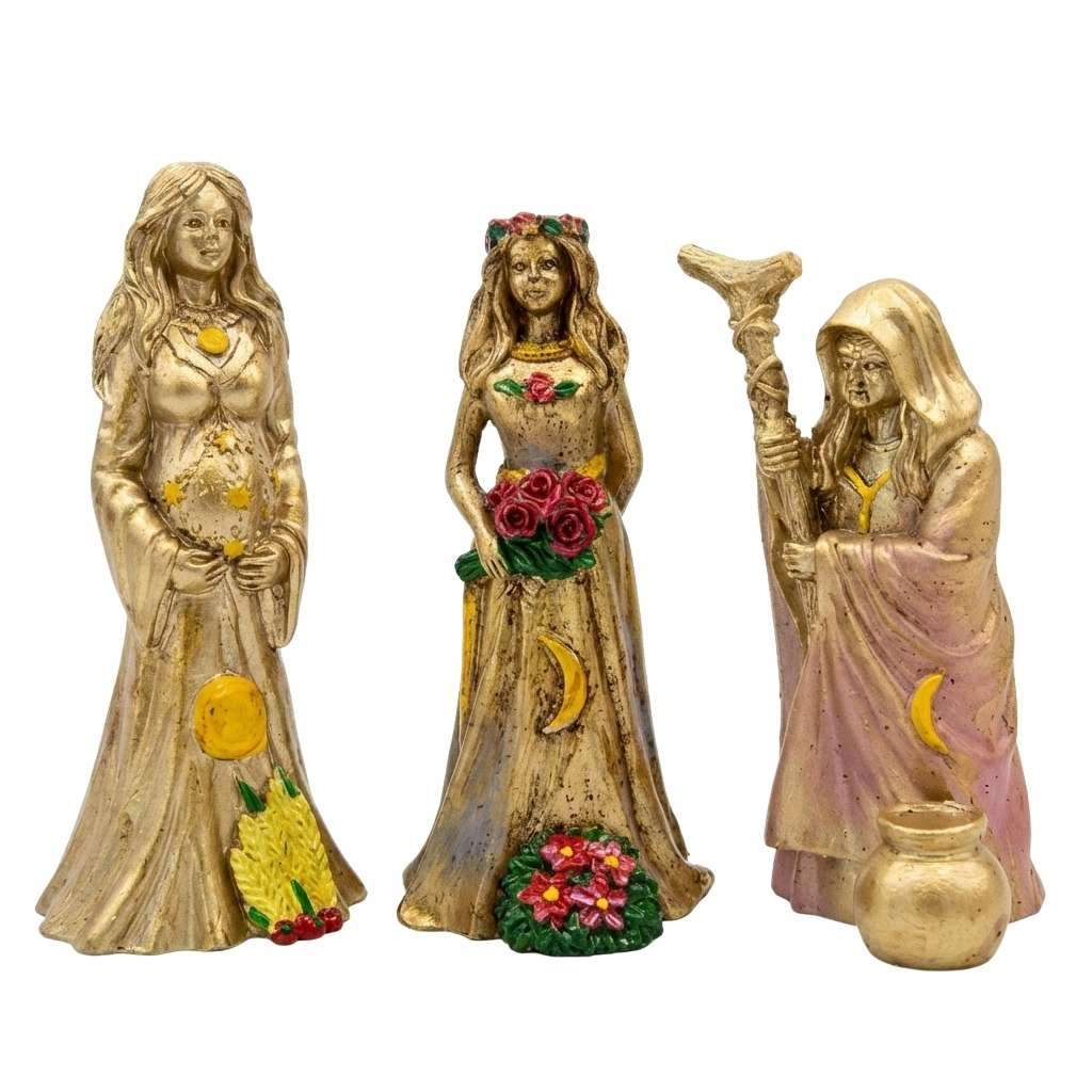 Triple Goddess figurine set of three showing Maiden, Mother, and Crone sculpted figures in white — Wiccan divine feminine altar statues.
