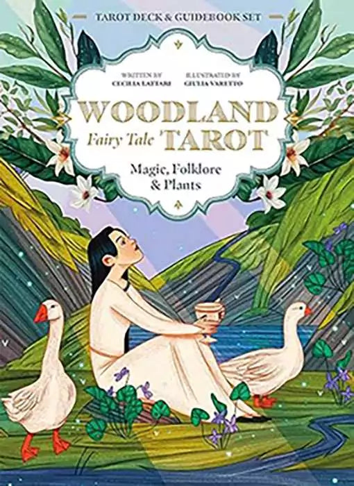 Woodland Fairy Tale Tarot box art of a young woman in a white dress kneeling in a lush forest beside two white geese, violets, and blossoms, subtitled Magic Folklore and Plants.