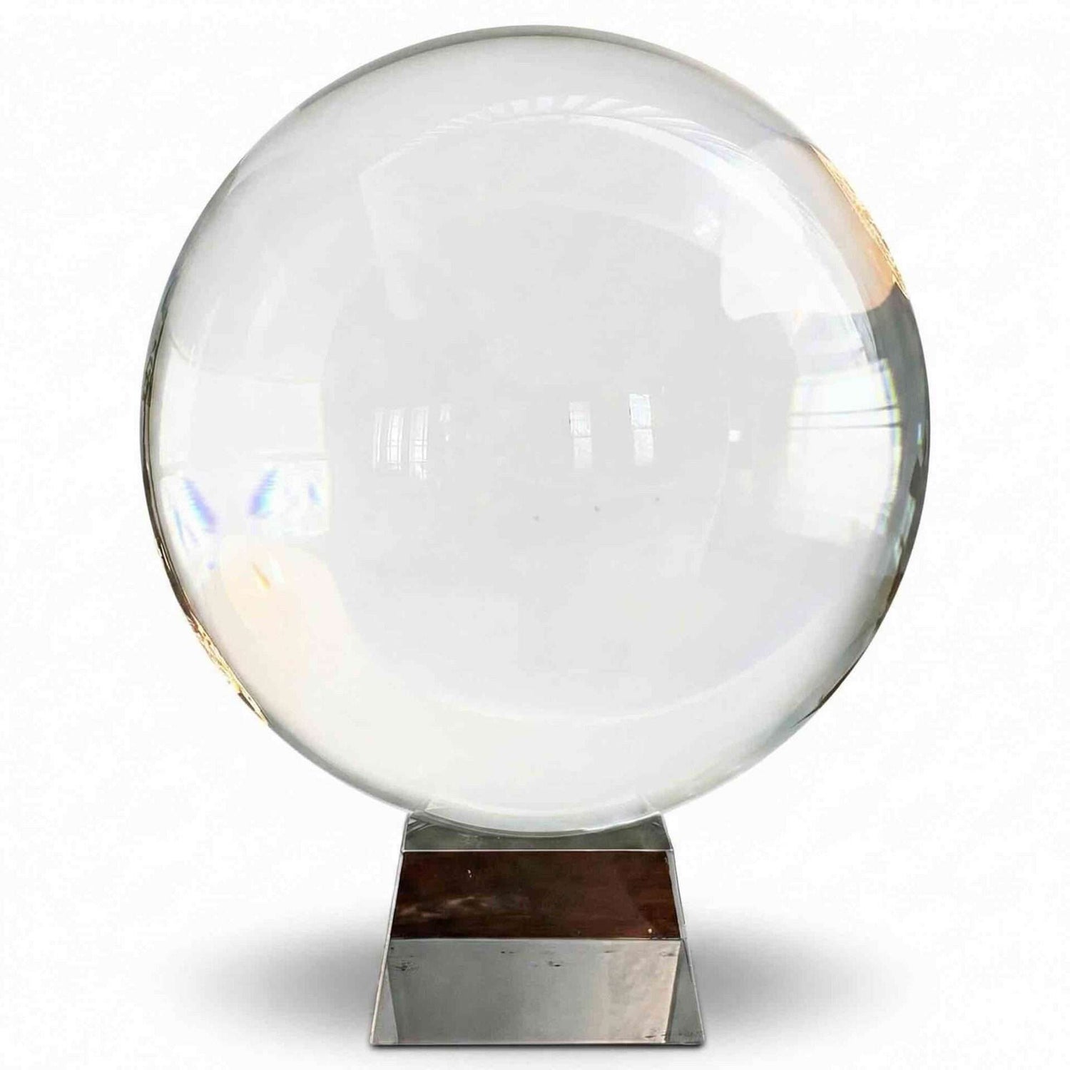 A large 200mm clear crystal ball on a metallic display stand reflecting light and creating visual distortions — an 8-inch polished quartz sphere for scrying, meditation, and altar display.
