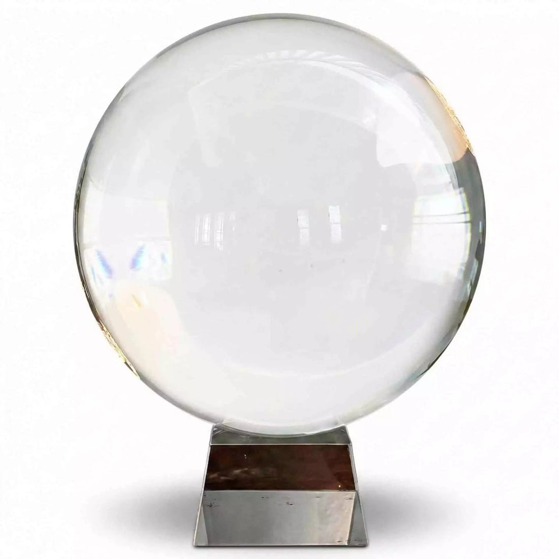 A large 200mm clear crystal ball on a metallic display stand reflecting light and creating visual distortions — an 8-inch polished quartz sphere for scrying, meditation, and altar display.