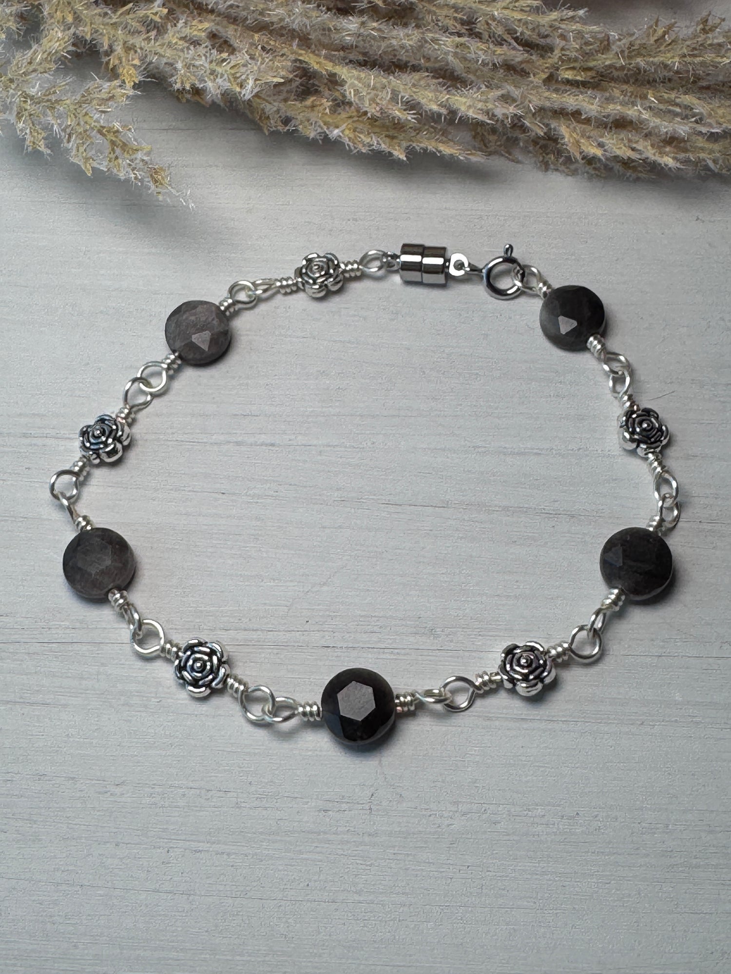 Silver Wire Wrapped Bracelet with Silver Obsidian Gemstones and flower charms.