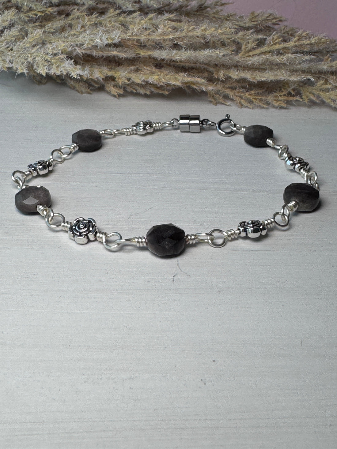 Silver Wire Wrapped Bracelet with Silver Obsidian Gemstones and flower charms.