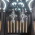 Black winged silver-tone cross dangle earrings with intricate gothic details.