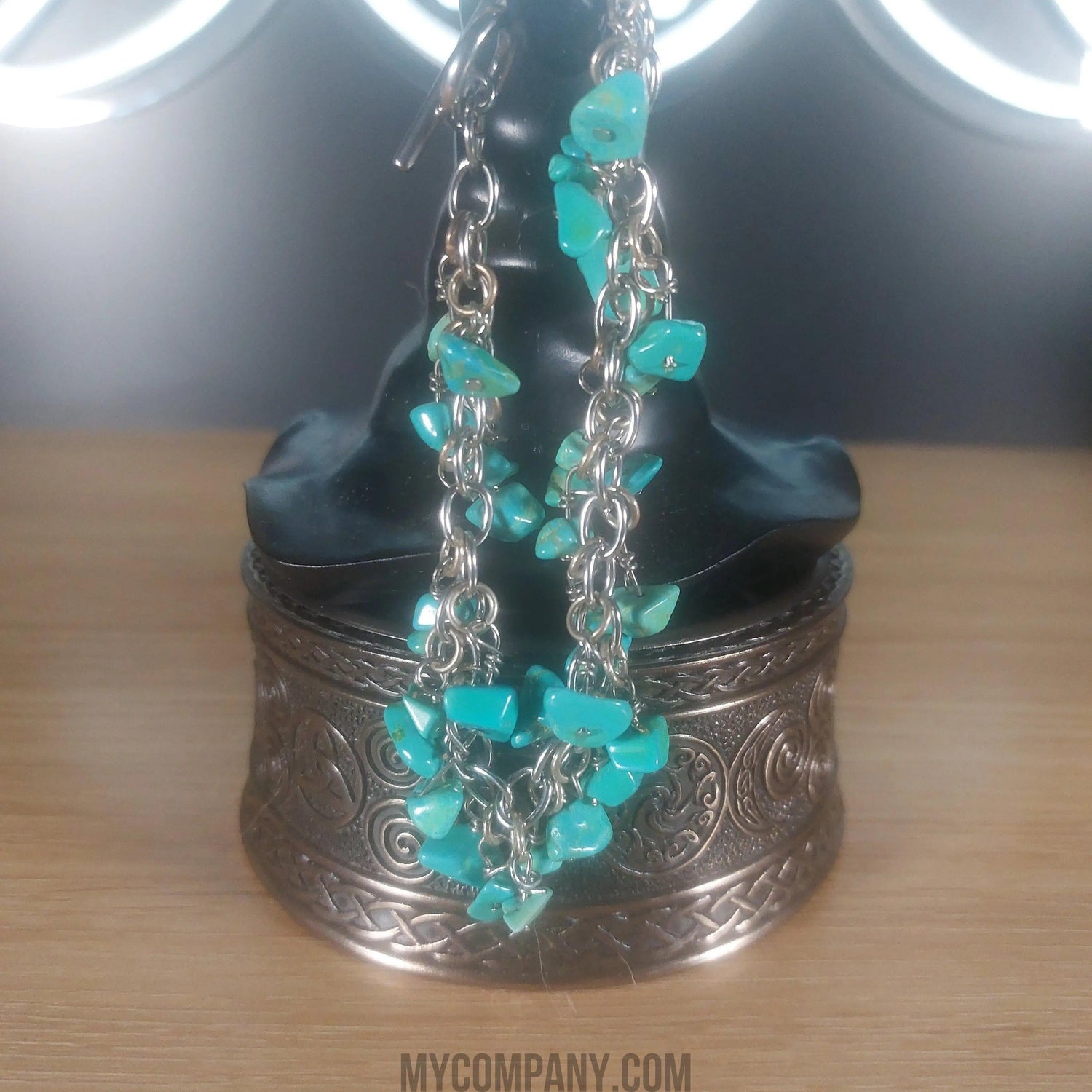 Silver stainless steel bracelet with dangling turquoise howlite gemstone chips.