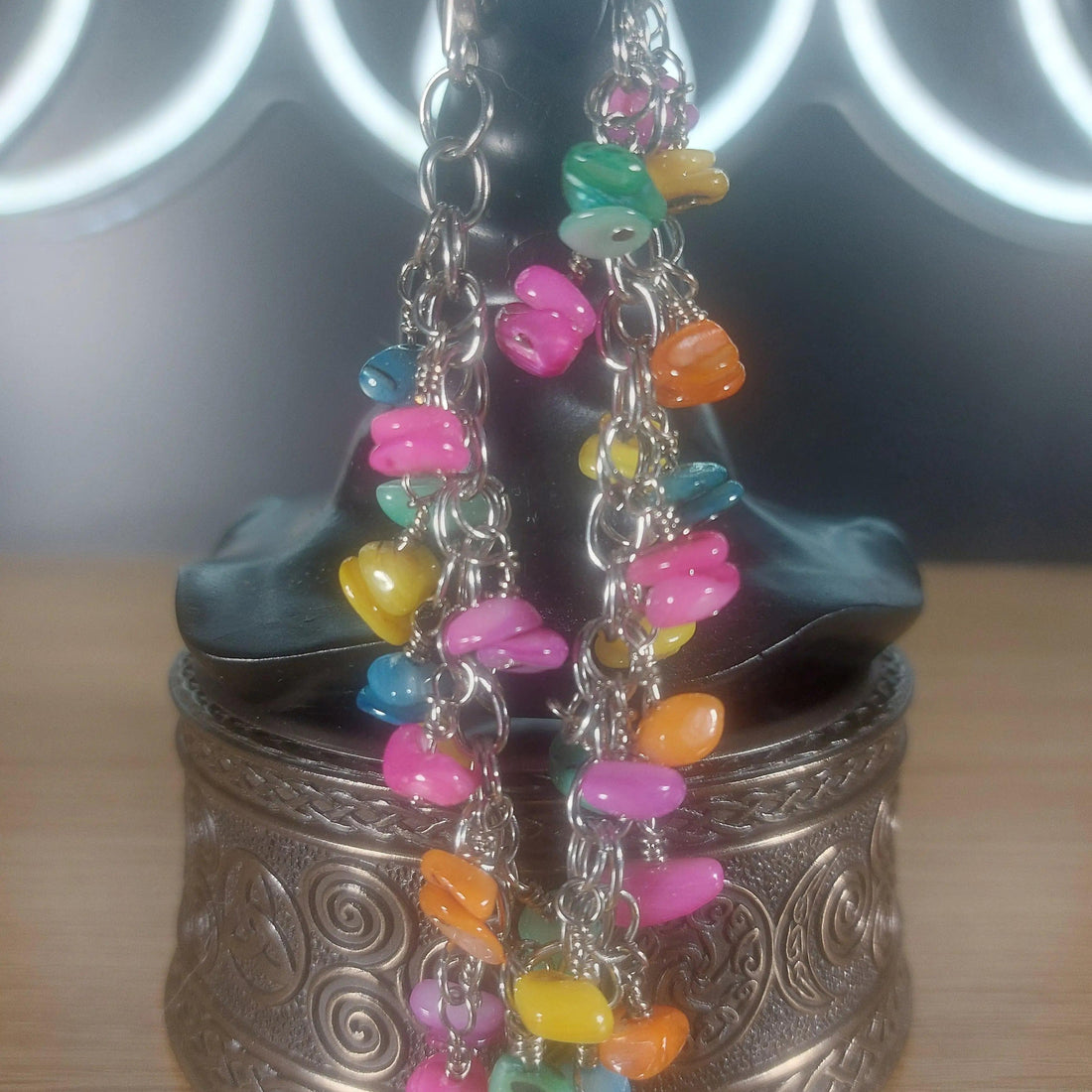 Pastel colored shell bracelet with stainless steel chain, featuring small, colorful shell beads.