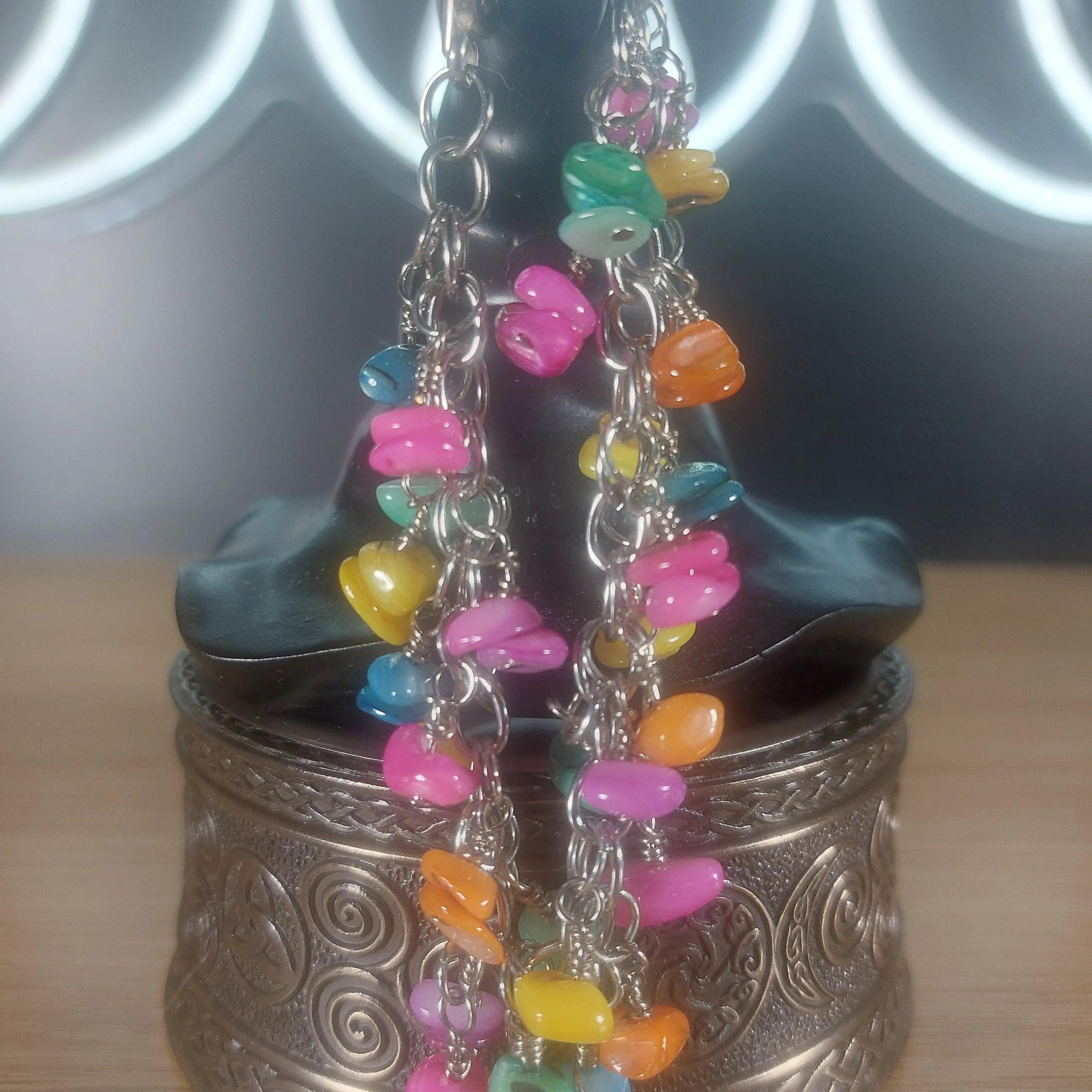 Pastel colored shell bracelet with stainless steel chain, featuring small, colorful shell beads.
