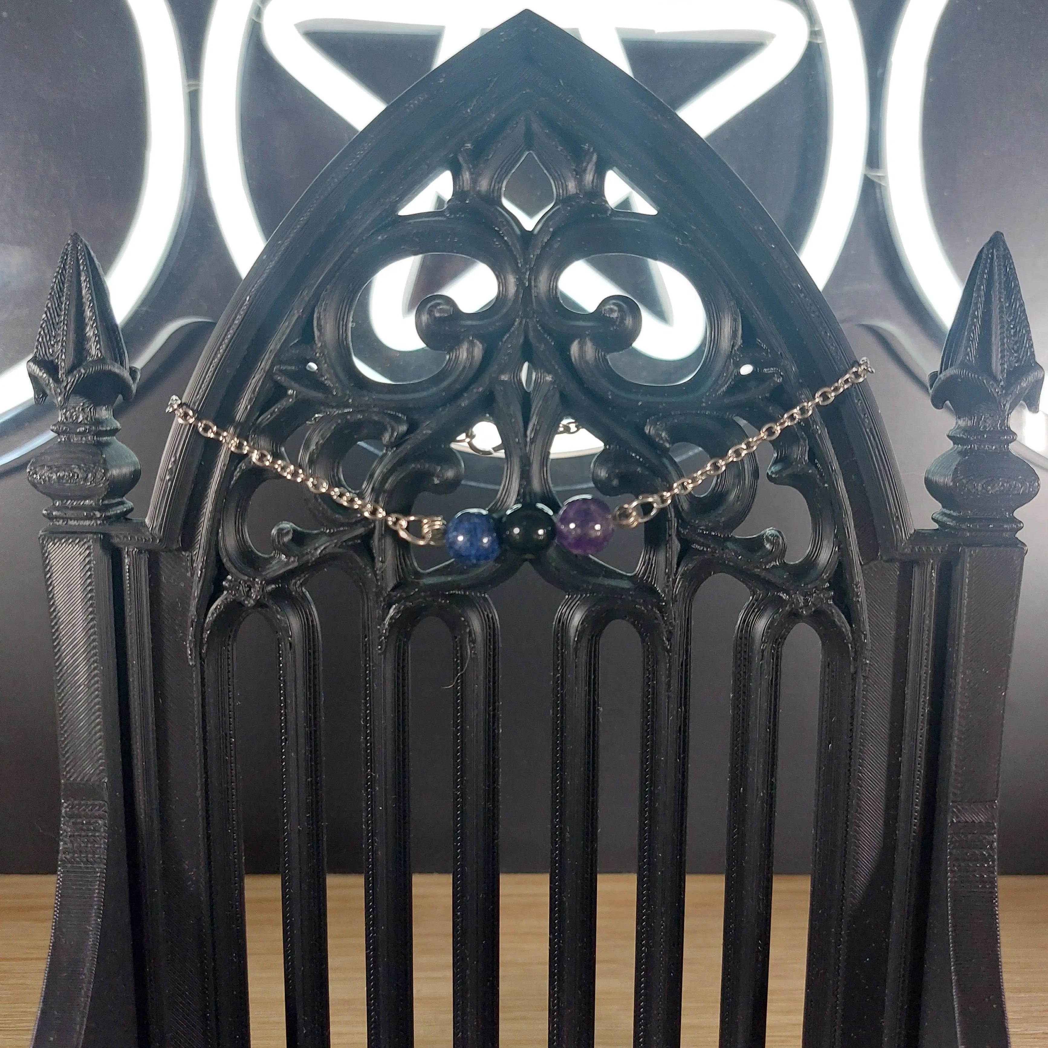 Sagittarius power stone bracelet with blue lapis lazuli, purple amethyst, and black obsidian beads on a gothic stand.