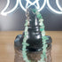 Green aventurine crystal chip bracelet with a silver toggle clasp on a dark display.