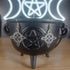 Silver tone Witches Knot dangle earrings in a black cauldron, with a glowing Triple Moon and Pentagram symbol in the background.