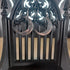 Silver tone metal crescent moon dangle earrings on a black gothic display stand.