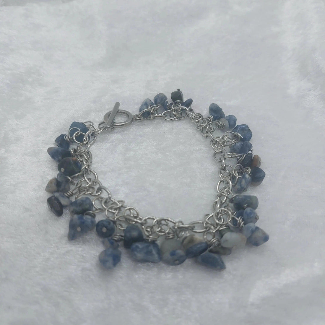 8in Sodalite chip bracelet with blue and white stones on a silver stainless steel chain.