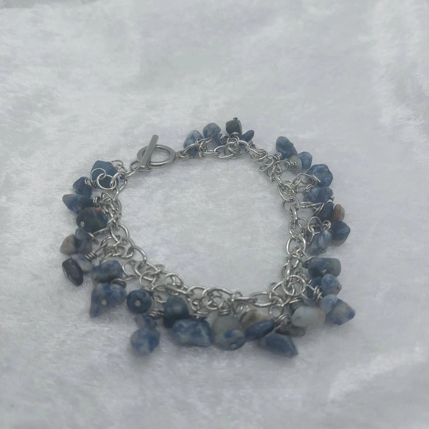 8in Sodalite chip bracelet with blue and white stones on a silver stainless steel chain.