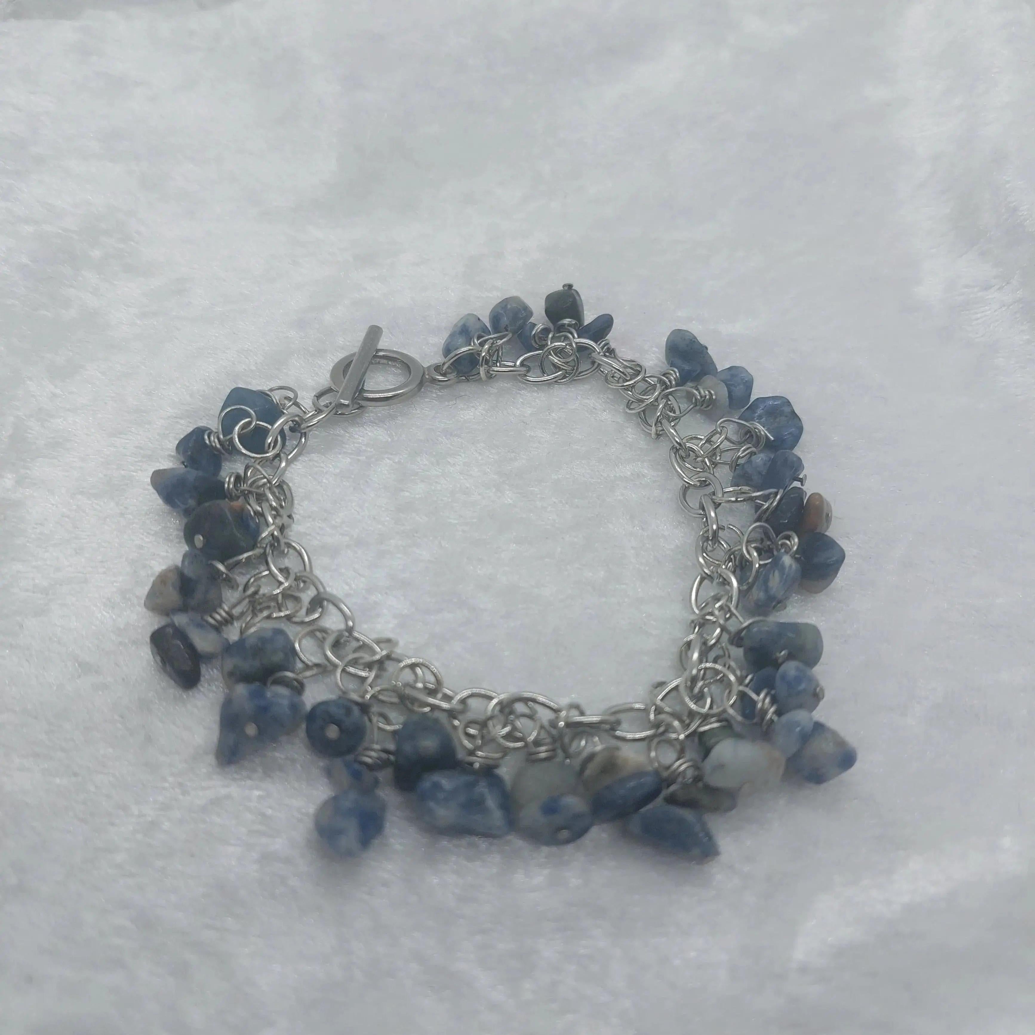 8in Sodalite chip bracelet with blue and white stones on a silver stainless steel chain.